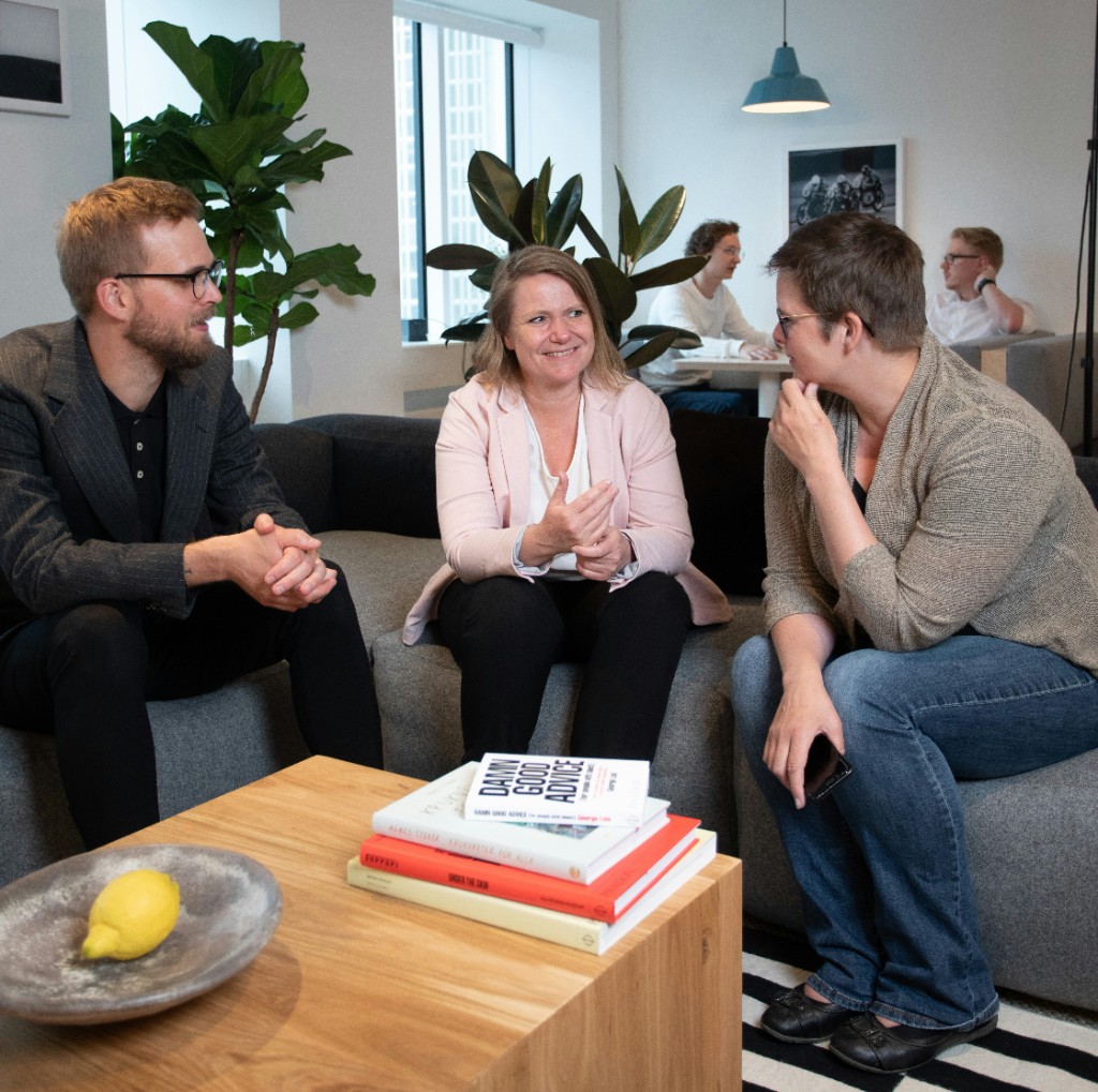 Colleagues collaborating in a modern office lounge